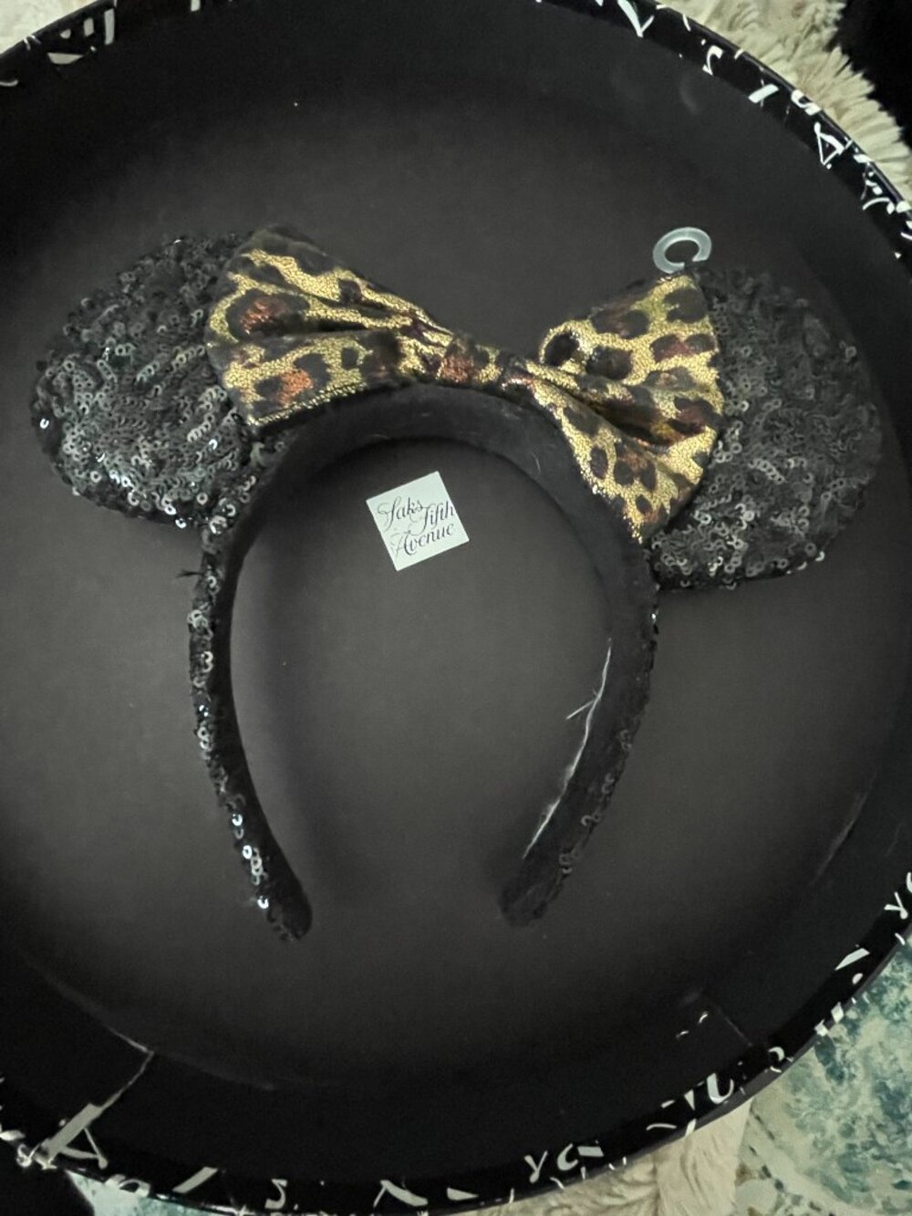 Minnie Mouse black sequin ear headband with a gold and black leopard print bow